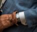 person wearing blue leather gloves with watch