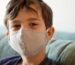 boy in blue crew neck shirt with white face mask